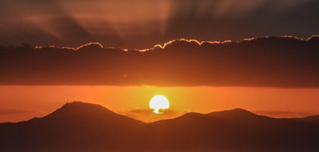 Sunset in the mountains. Panoramic view of the sun.の写真素材