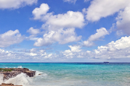 Tropical beach with turquoise sea and blue sky with clouds