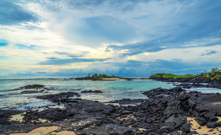 Beautiful seascape with turquoise water and lava rocks at sunset