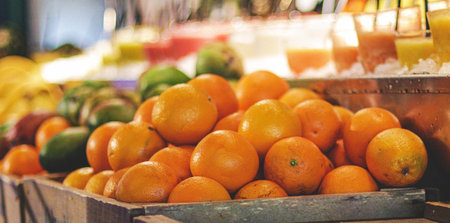 Fresh oranges and other fruits on the counter of a grocery store.の写真素材