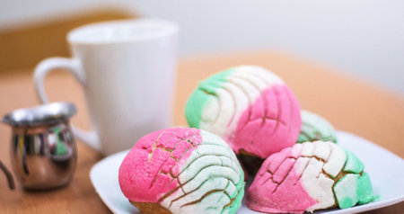 Close up of colorful marshmallows on a plate with cup of coffee
