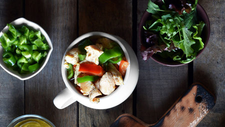 Chicken salad with green bell pepper and arugula in a bowlの写真素材