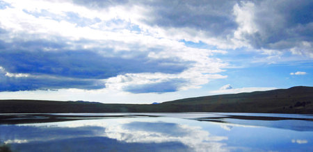 Lake with reflection of clouds in the water. Russia. Siberia.の写真素材