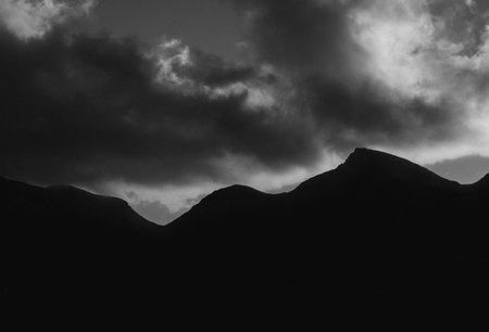 Stormy clouds over the mountains. Black and white monochrome image.