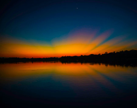 Beautiful sunset on the river. Colorful sky with clouds.の写真素材
