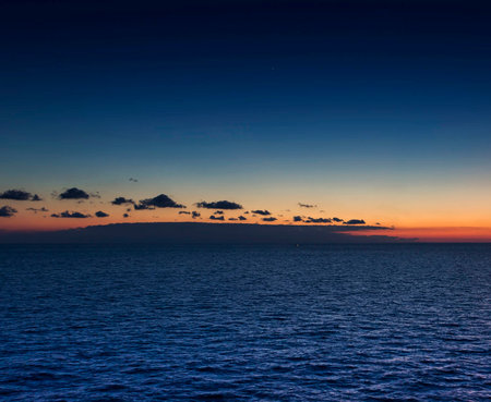 beautiful sunset over the sea with clouds on the sky and horizonの写真素材