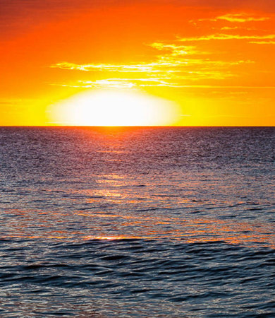 Sunset over the sea. Beautiful sunset over the sea. The sun sets over the ocean.の写真素材