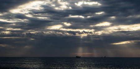 Seascape with a ship on the horizon and dark clouds in the sky