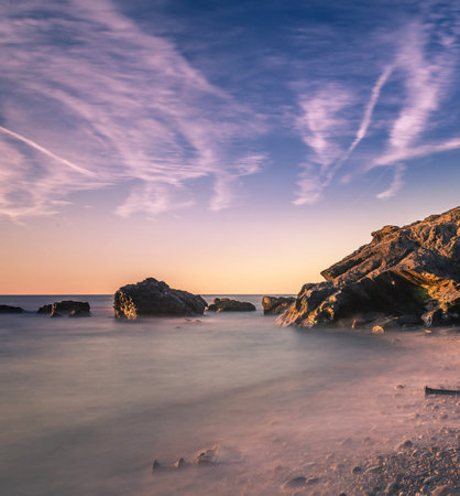 Beautiful seascape with rocks and sunset sky. Long exposure.の写真素材