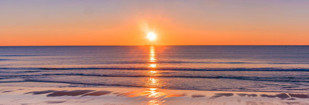 Sunset over the sea. Panoramic view of the beach.の写真素材