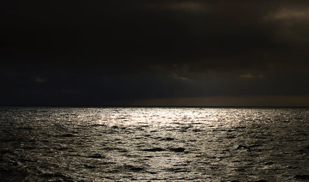Stormy sky above the sea. Dramatic sky with dark clouds.の写真素材