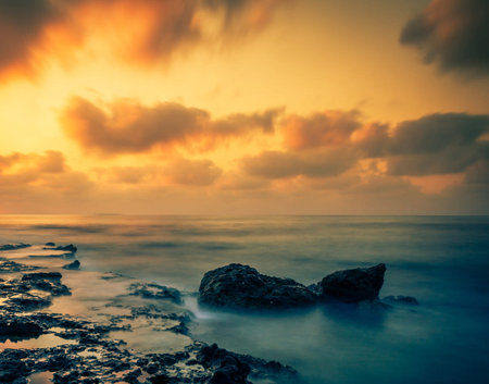 Beautiful seascape at sunset. Dramatic sky, long exposureの写真素材