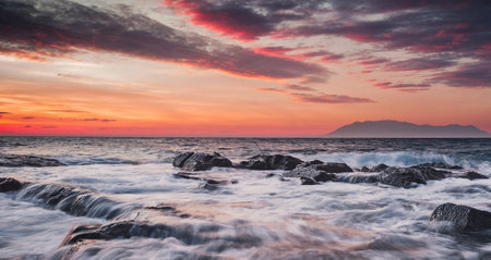 Beautiful sunset over the sea with rocks and waves. Nature backgroundの写真素材