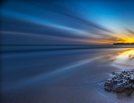 beautiful long exposure seascape at sunset with motion blur effectの写真素材