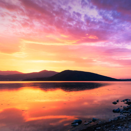 Beautiful sunset over the lake in the mountains. Nature background.の写真素材