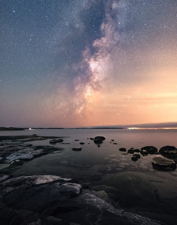 Milky Way over the sea. Long exposure photograph, with grainの写真素材