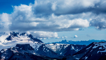 Panoramic view of the snow-capped mountains in the cloudsの写真素材