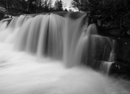 Long exposure of a waterfall in black and white with a blurred backgroundの写真素材