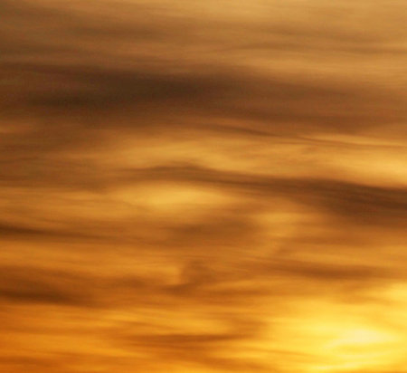 abstract background of the sky at sunset with clouds and sunbeamsの写真素材