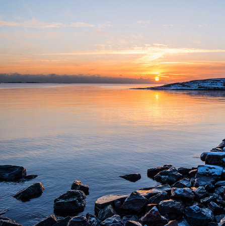 Sunset over the sea in winter. Beautiful winter landscape. The sun goes down.の写真素材