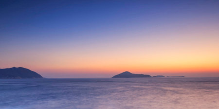 Sunset over the sea. Panorama of the sea and mountains.の写真素材