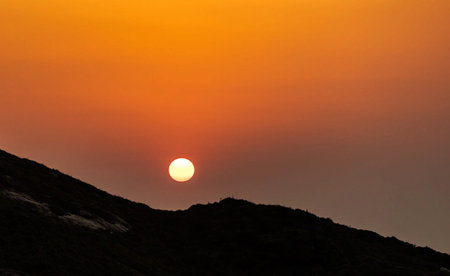 Beautiful sunset on the mountain. The sun sets over the mountains.の写真素材