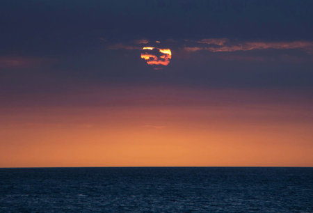 Sunset over the sea. The sun is reflected in the water.