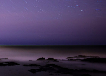 Night sky and stars over the sea. Long exposure photograph with long exposure.の写真素材