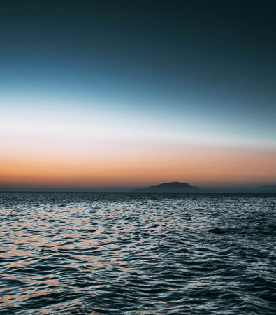 Sunset over the sea with mountains in the background. Toned.の写真素材