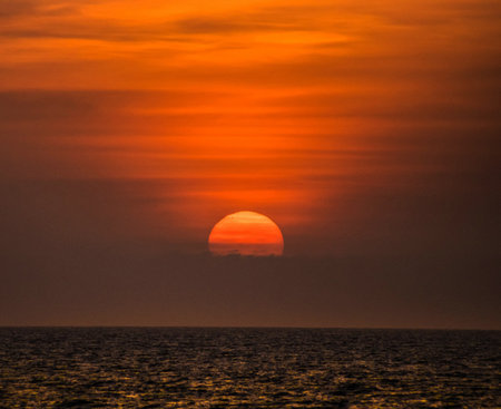 Sunset over the sea. The sun goes down over the sea.の写真素材