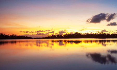 Beautiful sunset over the lake with reflection in the water, Thailandの写真素材
