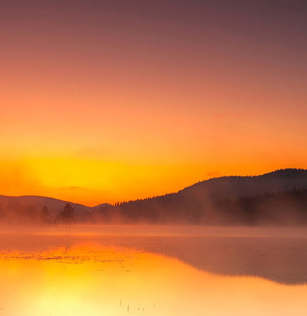 Sunrise over a lake in the Carpathian Mountains, Ukraineの写真素材