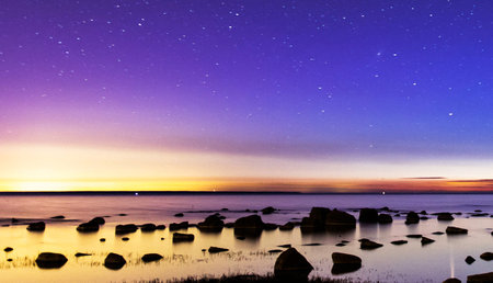 Starry sky over the sea at sunset. Long exposure photo.の写真素材