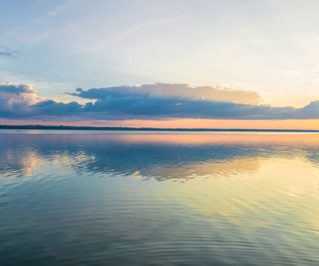 Beautiful sunset on the lake with reflection in water. Nature background