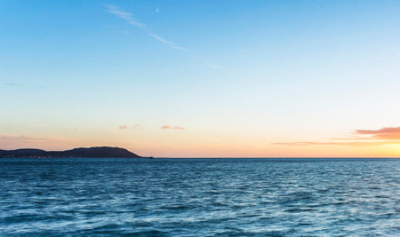 Sunset on the sea. Seascape with blue sky and clouds.