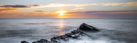 Sunset over the sea. Long exposure. Panoramic image.