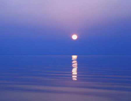 Sunset on the sea with reflection of the sun in the waterの写真素材