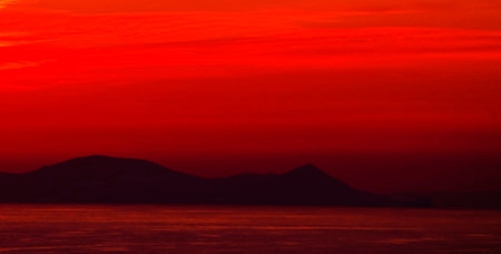 Sunset over the sea with mountains in the background, Greece.の写真素材