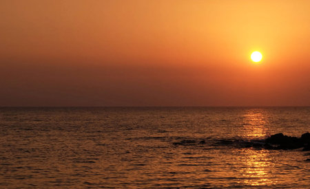 Sunset over the sea. Sunset on the sea. The sun sets over the sea.の写真素材