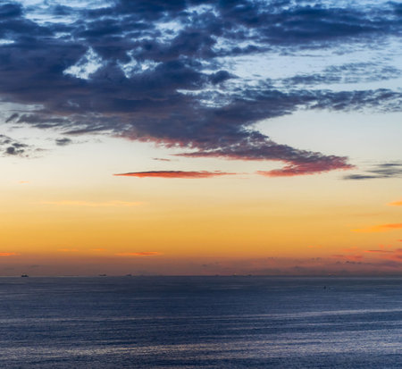 Beautiful sunset over the sea. Colorful sky with clouds.の写真素材