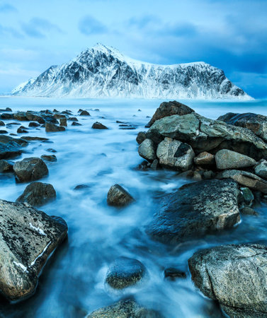 Long exposure image of snow-capped mountain peaks in Lofoten islands, Norwayの写真素材