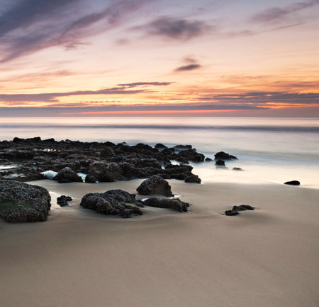 Beautiful seascape with rocks at sunset. Long exposure.の写真素材