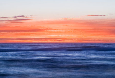 beautiful sunset over the sea, long exposure photo with motion blurの写真素材