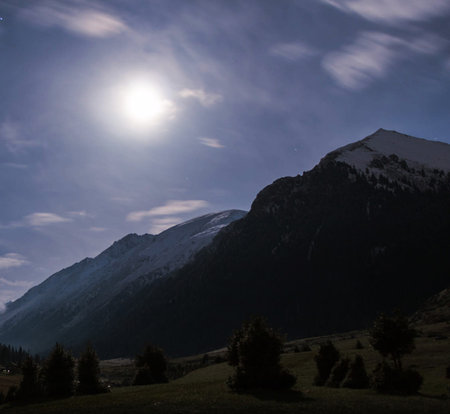 mountains in the alps under the blue sky with white cloudsの写真素材