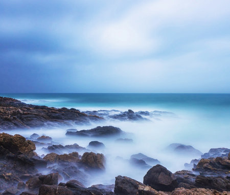 beautiful seascape with rocks and blue sky. long exposureの写真素材