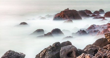 Long exposure of rocks in the sea with a long exposure effect.の写真素材