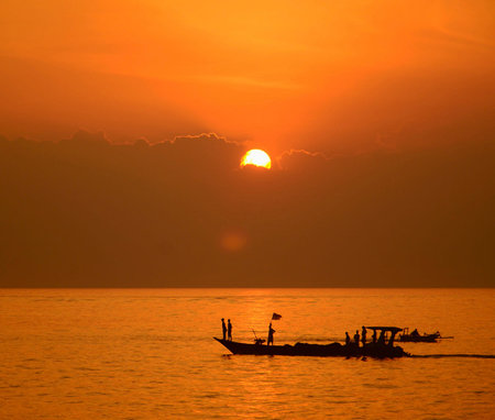 Silhouette of fisherman boat in the sea at sunset, Thailand
