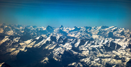Aerial view of Himalaya mountain range with snow and blue sky
