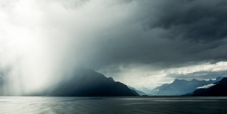 Rain over the fjord and mountains in Alaska, USA.