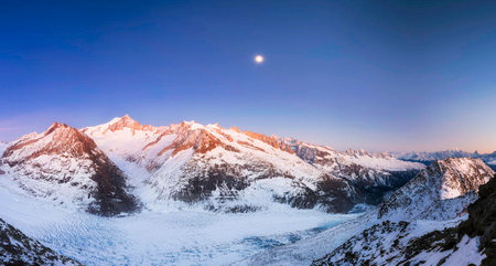 Beautiful mountain landscape with full moon in the sky. Panorama
